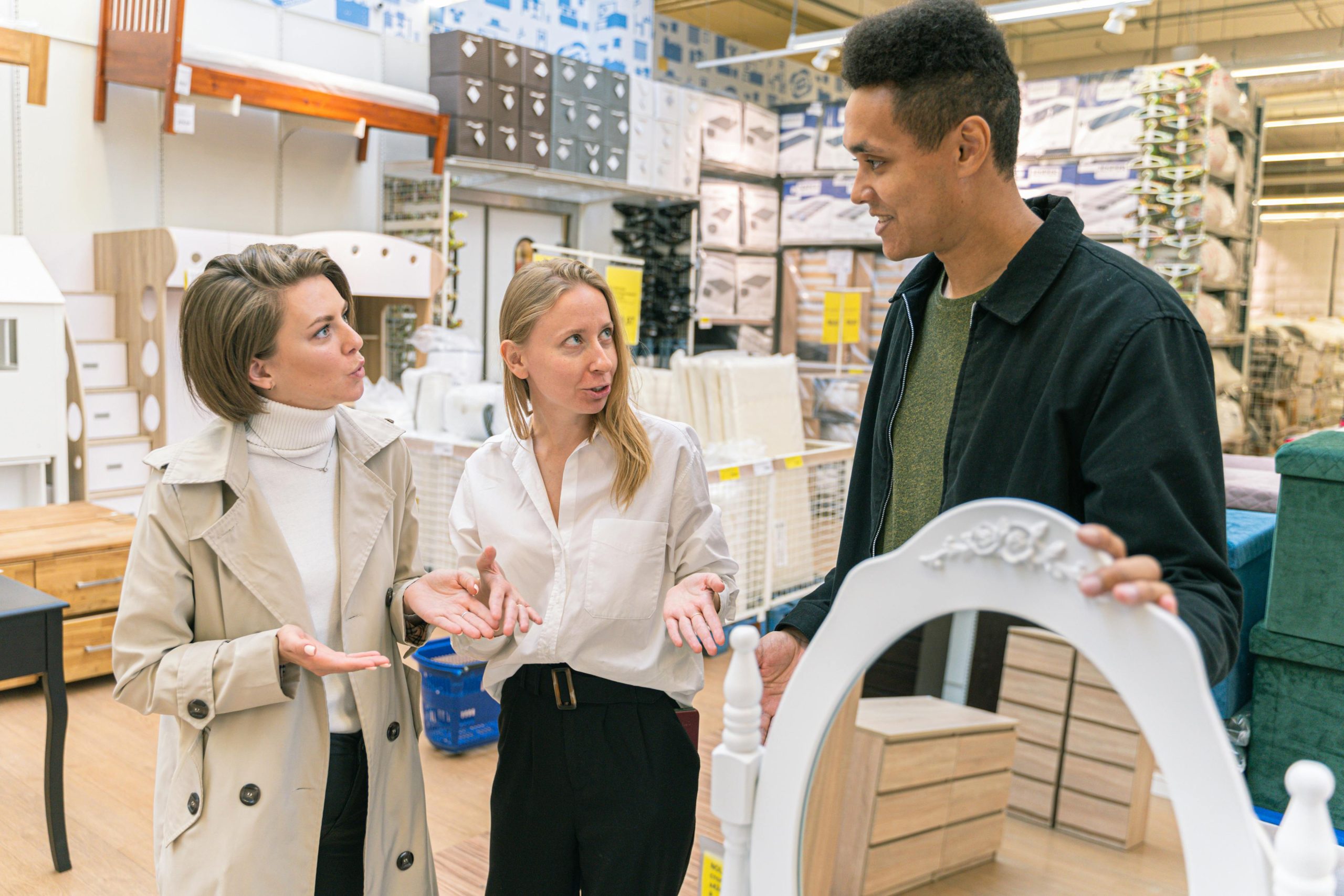 A team of professionals discussing product arrangement in a retail store.